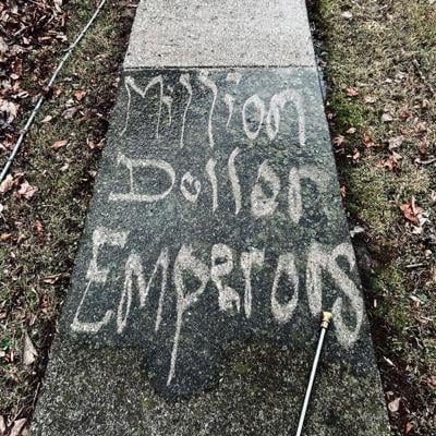 Album art for Nashville supergroup Million Dollar Emperors’ self-titled debut album. Color photo of the band’s name written on a dirty section of concrete sidewalk in negative space using a pressure washer.