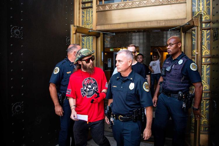 A neo-Nazi being escorted out of city hall, July 16, 2024