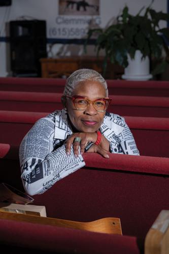 Clemmie Greenlee sitting in the red pews at a church in North Nashville