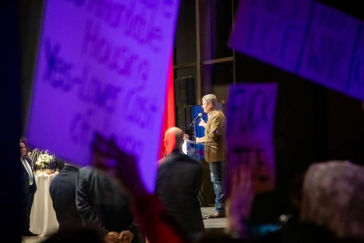Protesters gather outside the Tennessee State Museum as Gov. Bill Lee speaks inside