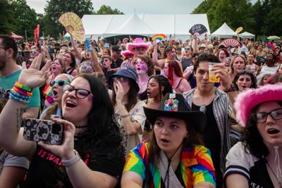 Color photo of fans at Nashville Pride Festival in 2025, wearing rainbow gear and fuzzy pink cowboy hats