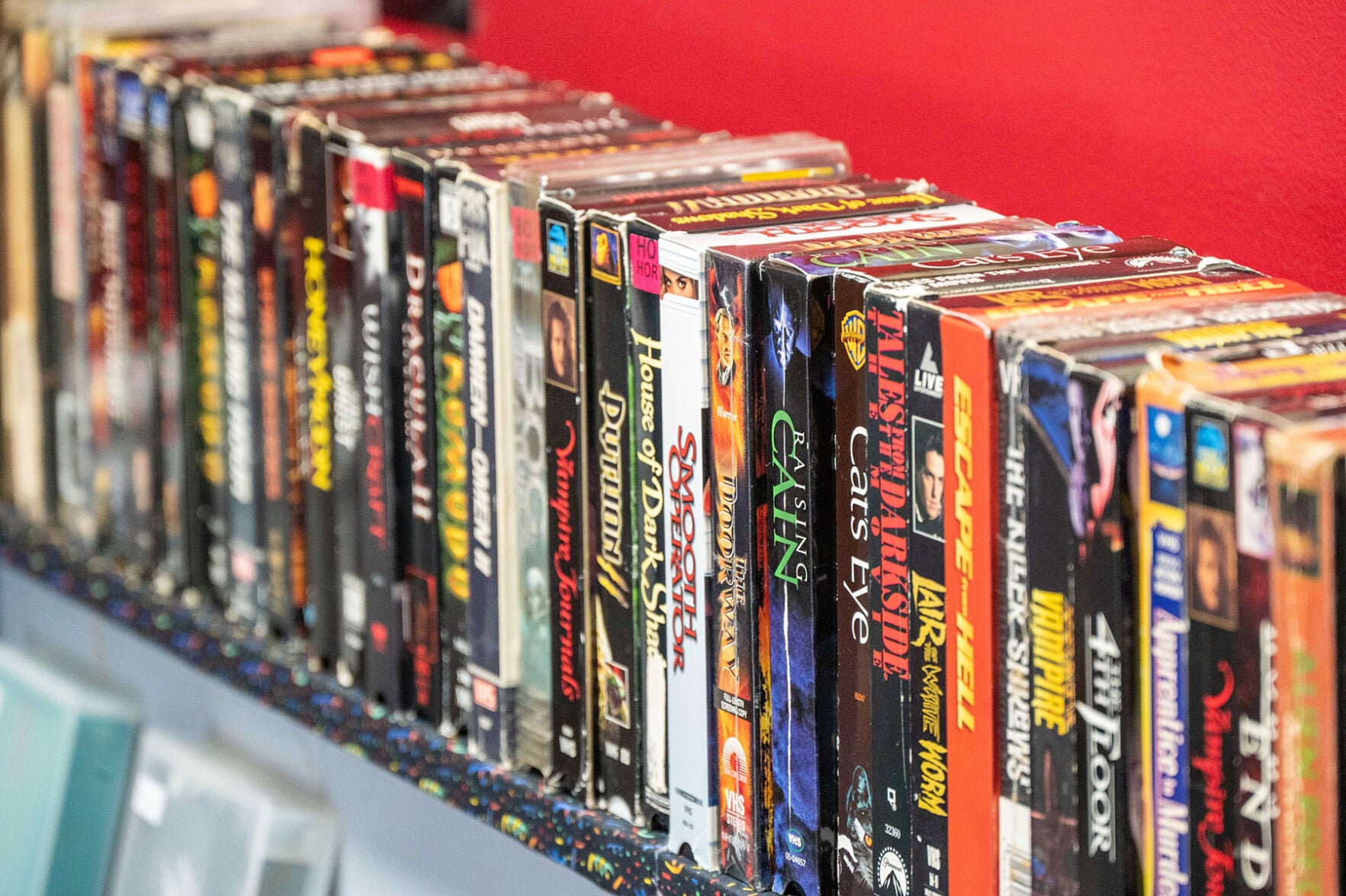 A shelf of VHS tapes at Danger Zone Video