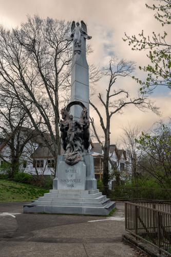 A stone obelisk with an angel at the top and a robed figure flanked by horses near the bottom. Beneath the figure is a stone tablet reading “Battle of Nashville 1864.”