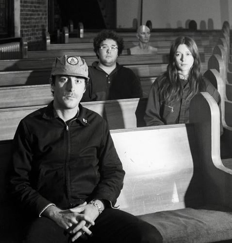 Power Clinic press photo each member of the band sits on a different church pew
