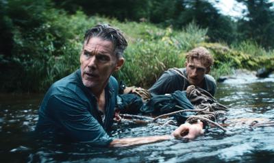 Ethan Hawke navigates a river in a still from 'The Weight'
