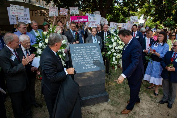 Anti-abortion advocates including numerous Republican lawmakers applaud the unveiling of an anti-abortion memorial, June 24, 2026