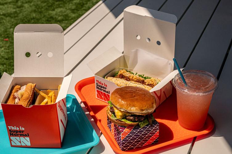 A sandwich and burger on a picnic bench from SuperNormal