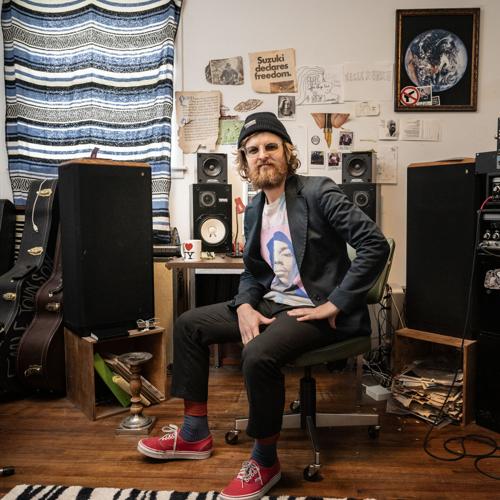 Color photo of Nashville musician Eagle Johnson, seated at the computer in his home music studio that serves as the nerve center for his startup music streamer Juniper