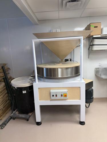 A mill inside of Perenn Bakery's kitchen