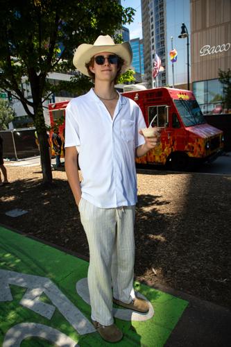 Color street style portrait of CMA Fest fan Dylan Mount, sporting lightweight fabrics appropriate for the summer heat.