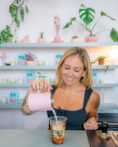 A woman pours milk into a plastic cup labeled Kettner