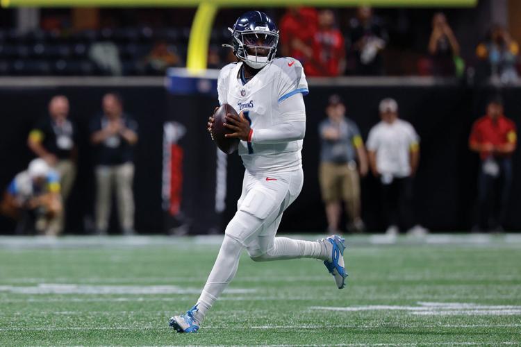 Cam Ward holding the football and running