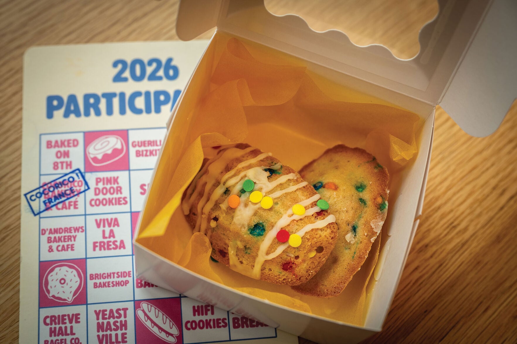 A box of two funfetti madeleines, dots of color brightening up the classic French cookie