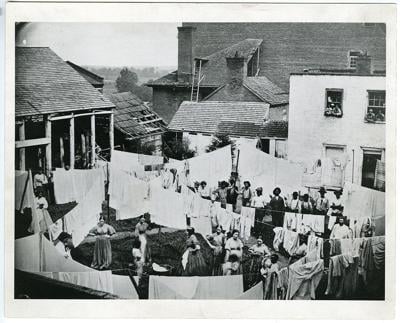 People, possibly sex workers, do laundry at a Civil War-era hospital
