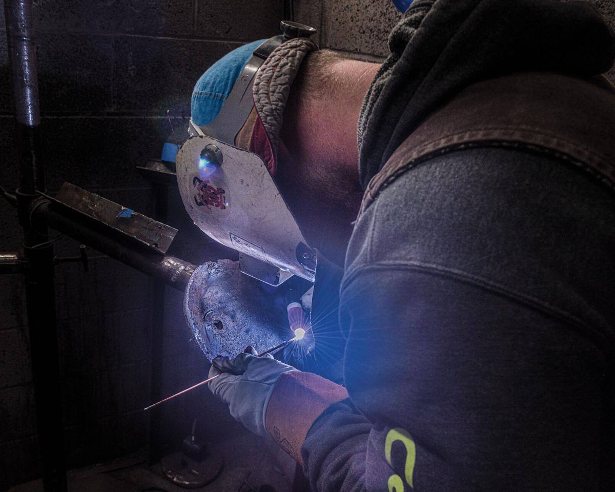 A pipefitter welding at Local 572