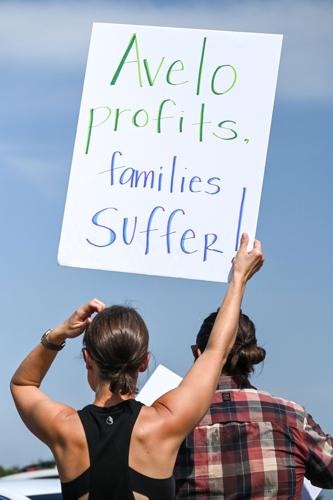 Protest sign reading "Avelo profits, families suffer!"