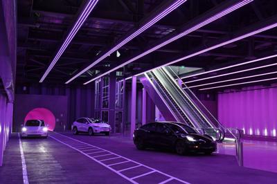 Three Teslas in the Las Vegas Loop under purple lighting