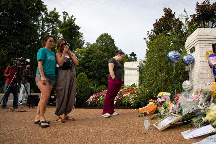 Dolly Parton fans mourn her passing, adding flowers and other mementos to a growing memorial at the gates of her Brentwood home the day after her death, Aug. 26, 2026