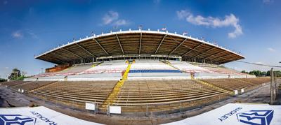 A fish-eye lens photo of a racetrack and empty bleachers
