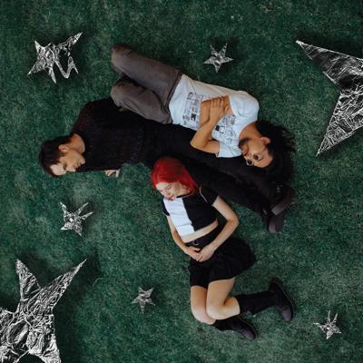 Cover art for Bleary’s ‘Little Brain,’ the Nashville Scene’s 2026 Best Indie-Rock Debut, featuring the band lying in green grass surrounded by silver stars