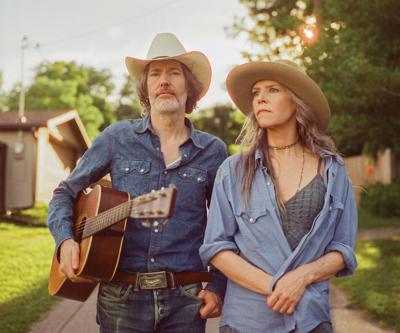 David Rawlings and Gillian Welch press photo artists stand on a path in the shade