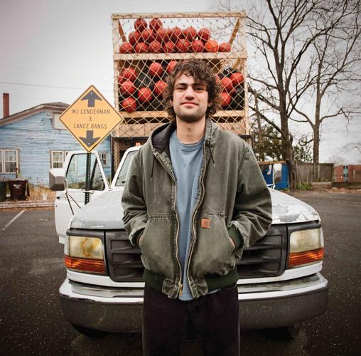 MJ Lenderman press photo artist stands in front of a truck loaded with basketballs