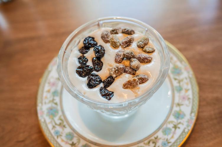 A bird’s eye view of a rice pudding with cherries and pistachios on top