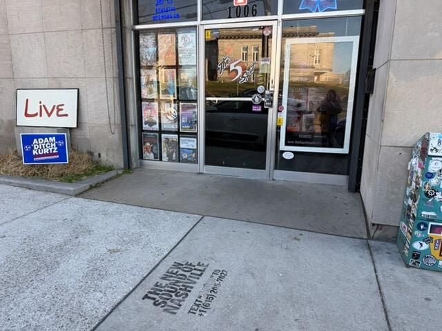 Photo of the front facade of East Nashville venue The 5 Spot, with an ad for forthcoming venue The Truth spraypainted on the sidewalk. The ad reads “The New Sound of Nashville Text “TRUTH” to (615) 205-7022”
