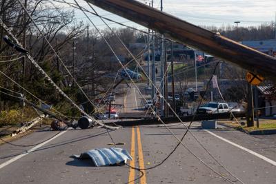 Utility poles, power lines and debris scattered across Madison's Nesbitt Lane on Dec. 10