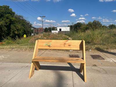 Wooden bench on the sidewalk at Dickerson Pike, placed by To Nashville With Love, the Nashville Scene's Best Act of Guerrilla Urbanism in 2026.