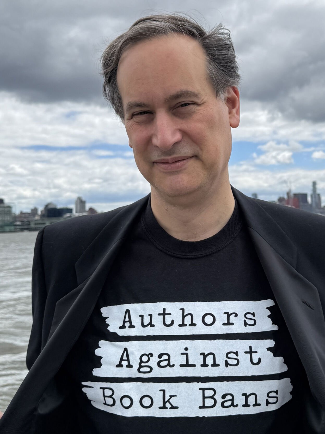 David Levithan wears a black T-shirt that reads "Authors Against Book Bans"