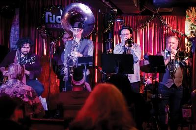 Seven-piece ensemble Rougarou Brass Band, led by Brook Sutton on sousaphone, performs at Rudy’s Jazz Room