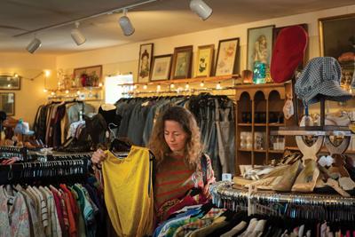 Person shopping among racks of vintage clothing at Anaconda Vintage, the Nashville Scene’s 2026 Best Vintage Clothing Store in Nashville