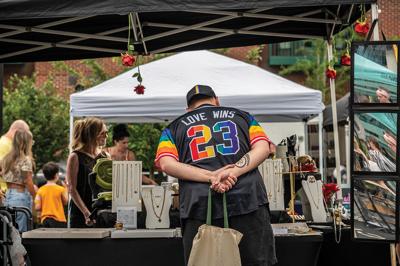 A customer in a rainbow 'Love Wins' jersey shops at the Gay Farmers Market
