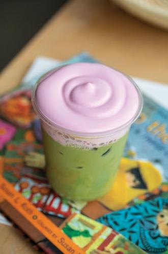 A matcha latte topped with a pinkish purple foam