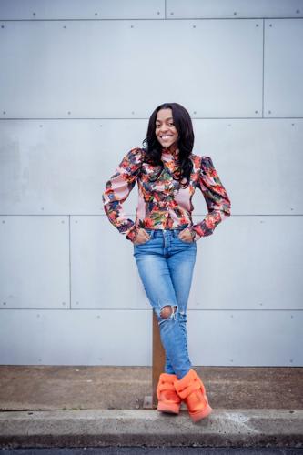 Averianna the Personality poses outside Cashville Gold and Silver Buyers on Eighth Avenue South.
