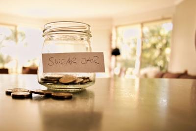 Swear jar filled with coins