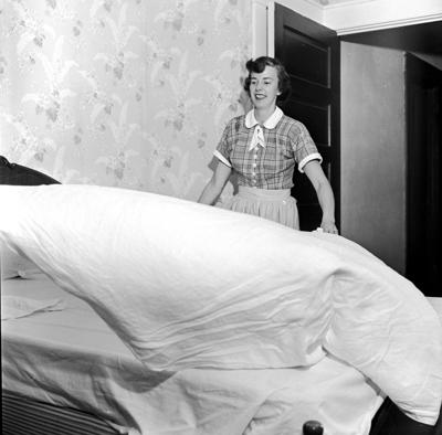 A woman makes a bed, 1954