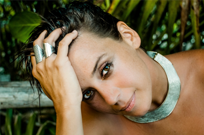 Artist Chan Marshall, aka Cat Power, looks into the camera with gelled hair and wearing two silver rings and a wide silver necklace.