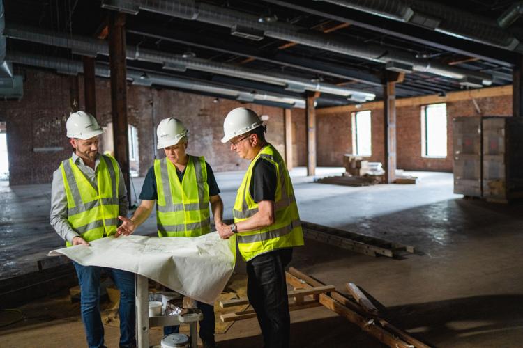 Brent Hyams, Zach Liff and Ray Waters review plans at the Main Stage in Cannery Hall.jpg