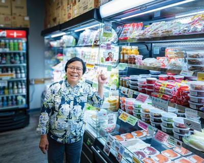 person pointing at shelves lined with colorful grocery products at Sonobana, the Nashville Scene’s 2026 Best Small Grocery in Nashville.