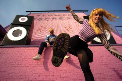 Snooper press photo in front of a pink wall decorated with large cardboard speakers frontwoman Blair Tramel is about to trample the camera