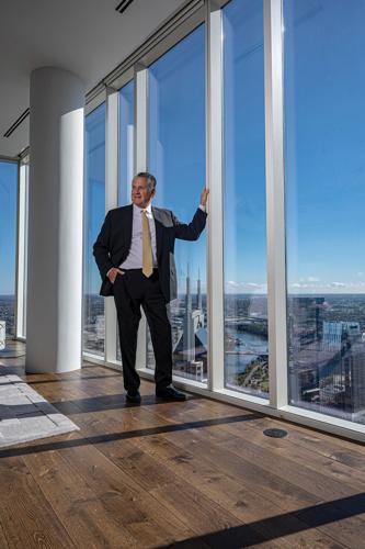 Tony Giarratana stands in front of a large window overlooking Nashville