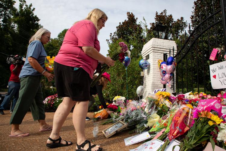 Dolly Parton fans mourn her passing, adding flowers and other mementos to a growing memorial at the gates of her Brentwood home the day after her death, Aug. 26, 2026