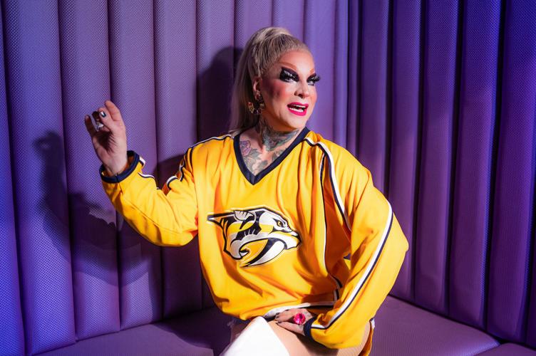 The Princess sitting down, wearing a predators' jersey with her right hand held up