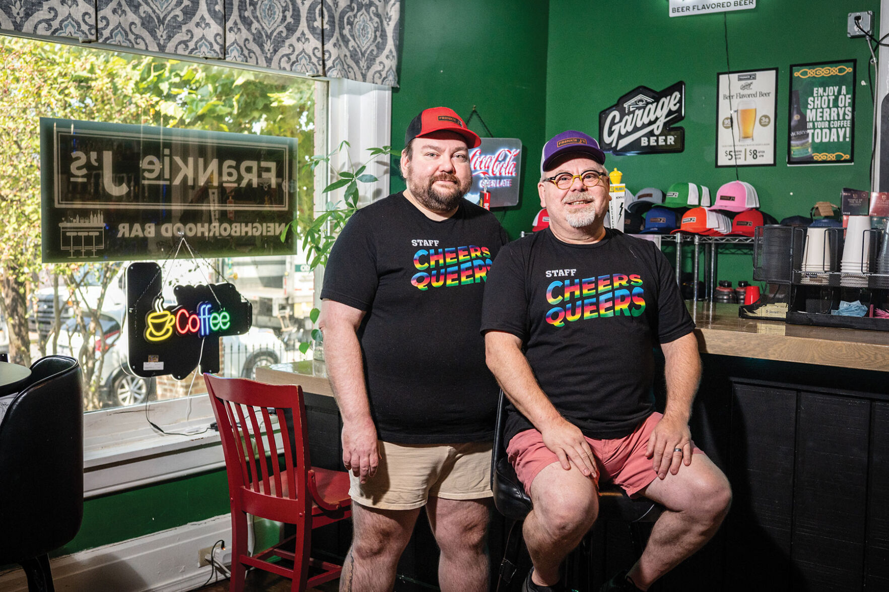 Jonathan Robinson and Jay Kill in black shirts reading "Cheers queers" in rainbow font at Frankie J's