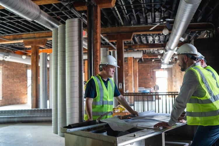 Zach Liff, Brent Hyams and Ray Waters discuss plans in The Mil at Cannery Hall.jpg
