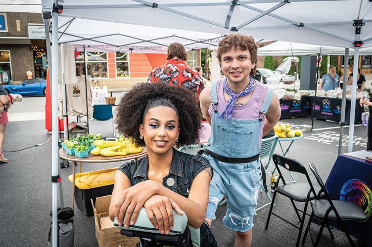 Two people at a stall at the Gay Farmers Market