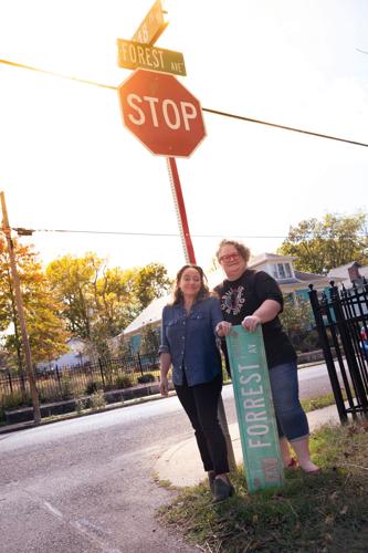 Erin Kice (left) and Keri Adams with new Forest Avenue and old Forrest Avenue signs
