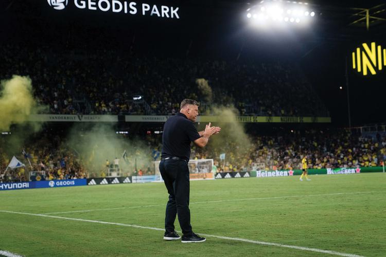 Nashville SC coach B.J. Callaghan cheering from the sidelines 